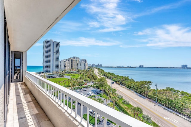 balcony featuring a view of city and a water view