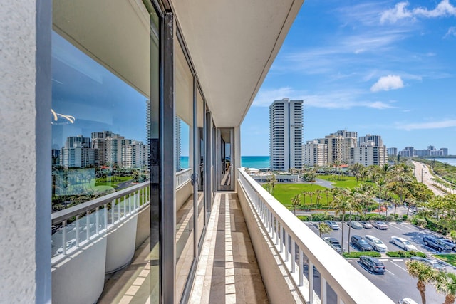 balcony featuring a city view and a water view