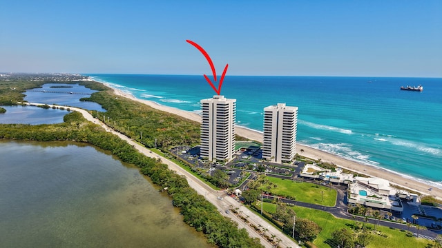 bird's eye view with a water view and a beach view