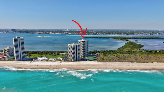 drone / aerial view with a city view, a view of the beach, and a water view