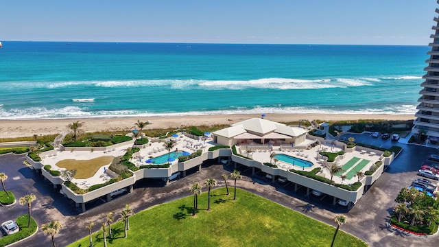 aerial view with a water view and a beach view