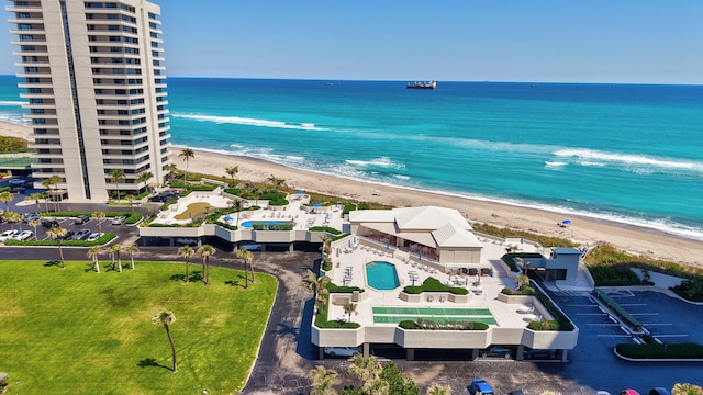 drone / aerial view with a water view and a view of the beach