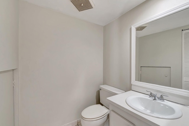 bathroom with visible vents, toilet, and vanity