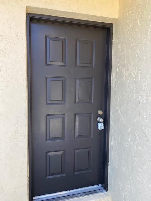 view of exterior entry featuring stucco siding