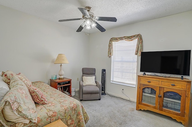 bedroom with a ceiling fan, baseboards, a textured ceiling, and carpet flooring