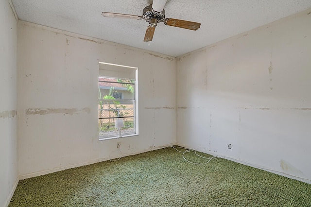 empty room with a textured ceiling and ceiling fan