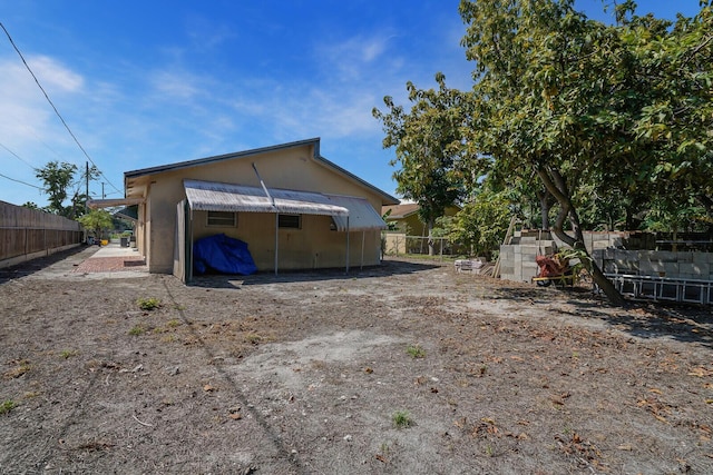 back of house featuring a fenced backyard