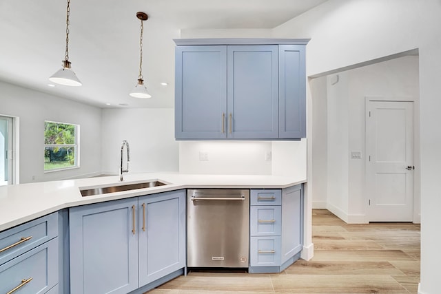 1085 26th St, Vero Beach, FL 32960 - kitchen featuring hanging light fixtures, dishwasher, light wood-style floors, and a sink