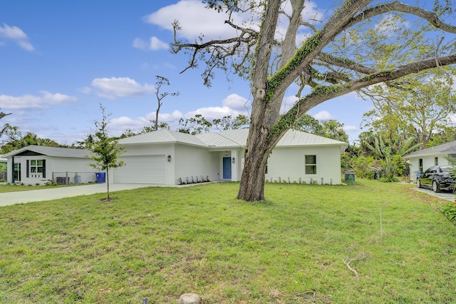 view of front of house with stucco siding, concrete driveway, a front lawn, a garage, and metal roof