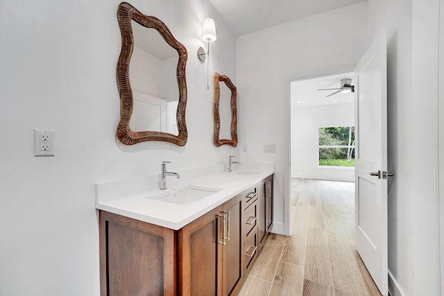 1085 26th St, Vero Beach, FL 32960 - bathroom with a sink, double vanity, a ceiling fan, and wood finished floors