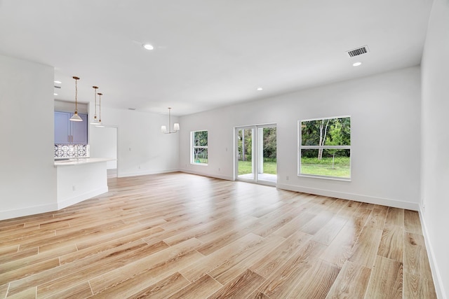 1085 26th St, Vero Beach, FL 32960 - unfurnished living room featuring baseboards, recessed lighting, light wood-style floors, and visible vents