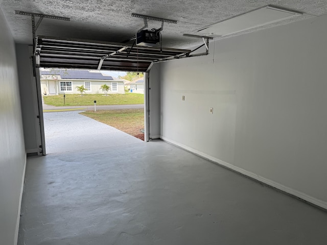 garage with baseboards and a garage door opener