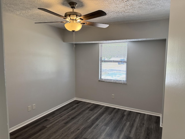 spare room with dark wood finished floors, a textured ceiling, baseboards, and ceiling fan