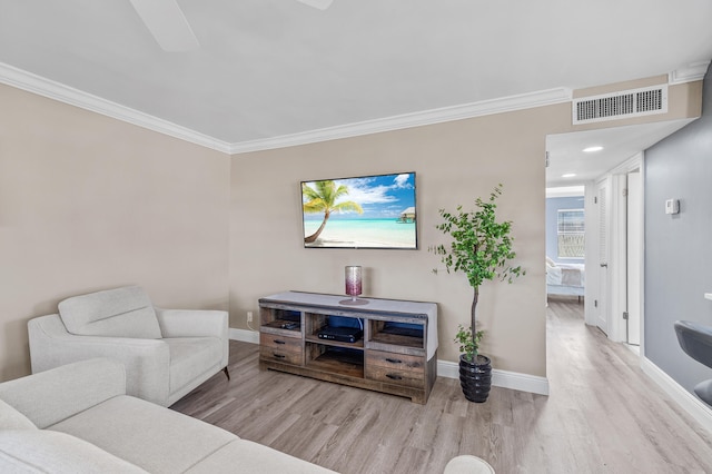 living room featuring crown molding, wood finished floors, visible vents, and baseboards