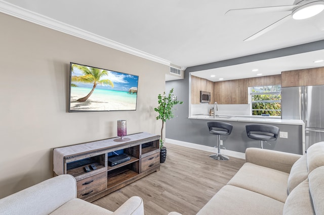195 Burgundy Unit E, Delray Beach, FL 33484 - living area with visible vents, ceiling fan, baseboards, light wood-type flooring, and ornamental molding