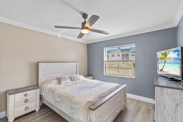 bedroom featuring a ceiling fan, light wood-type flooring, baseboards, and ornamental molding