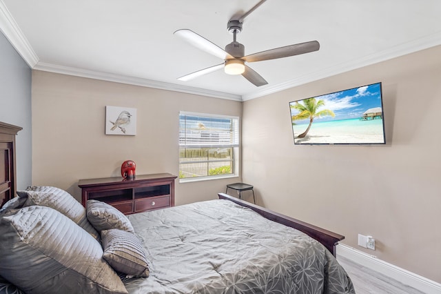 bedroom featuring ceiling fan, wood finished floors, baseboards, and ornamental molding