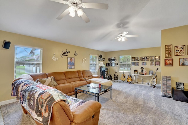 living area with carpet flooring, baseboards, and a ceiling fan