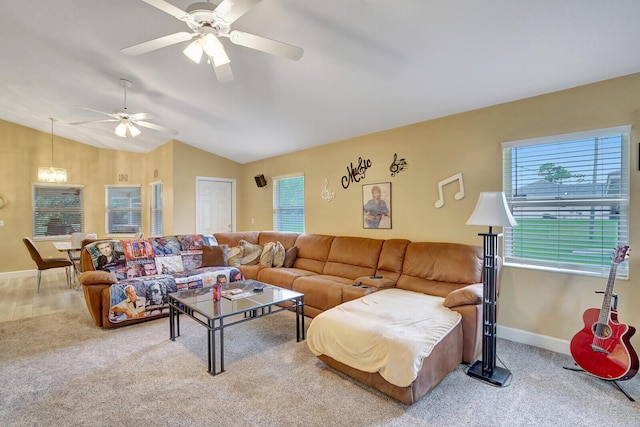 carpeted living area with baseboards, lofted ceiling, and a ceiling fan