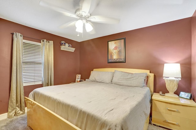 carpeted bedroom featuring baseboards and ceiling fan