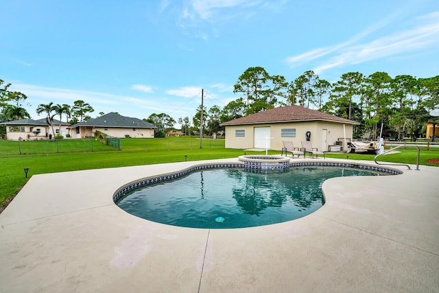 view of swimming pool featuring a patio area, a pool with connected hot tub, and a yard