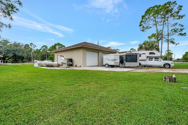 exterior space featuring a lawn, driveway, an attached garage, and stucco siding