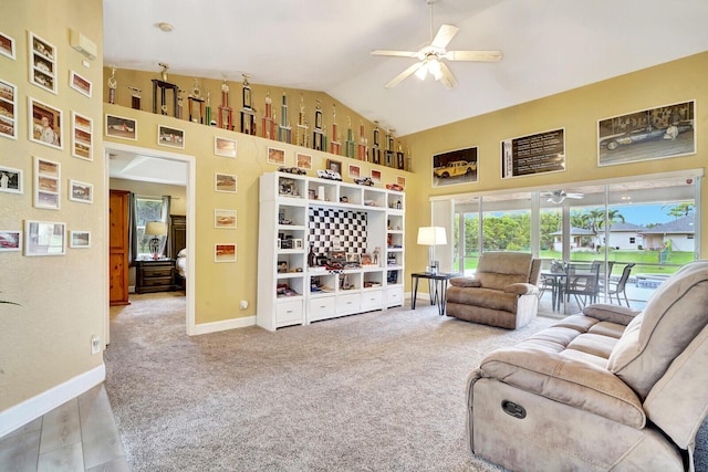 carpeted living room with baseboards, high vaulted ceiling, and ceiling fan