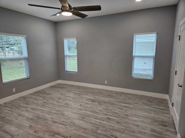 spare room with recessed lighting, baseboards, wood finished floors, and ceiling fan