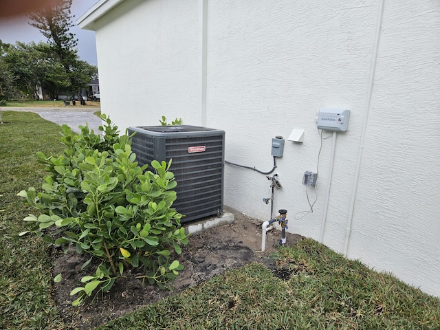 exterior details with cooling unit and stucco siding