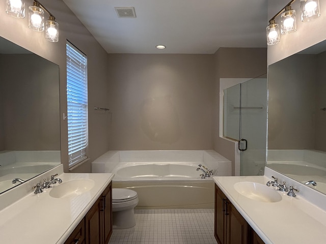 full bath featuring a sink, visible vents, a garden tub, and two vanities