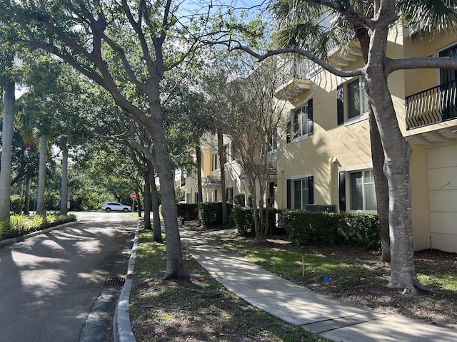 view of street featuring sidewalks, curbs, and traffic signs