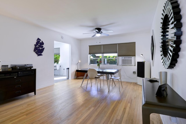 dining area featuring cooling unit, light wood-type flooring, baseboards, and ceiling fan