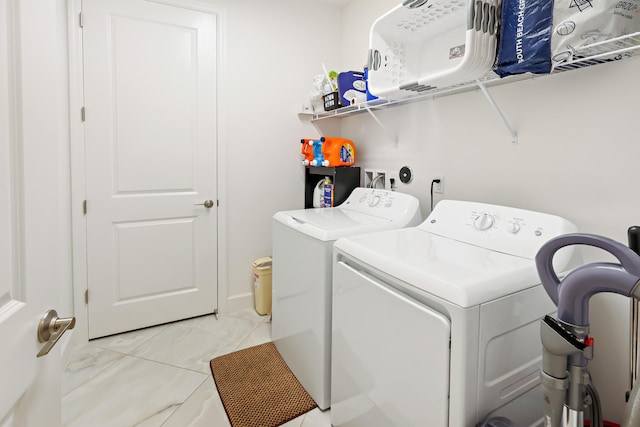 clothes washing area with washer and dryer and laundry area