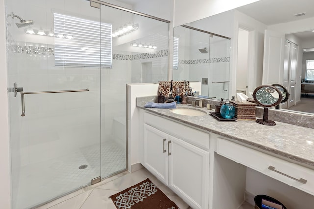 bathroom featuring visible vents, a stall shower, vanity, and tile patterned flooring