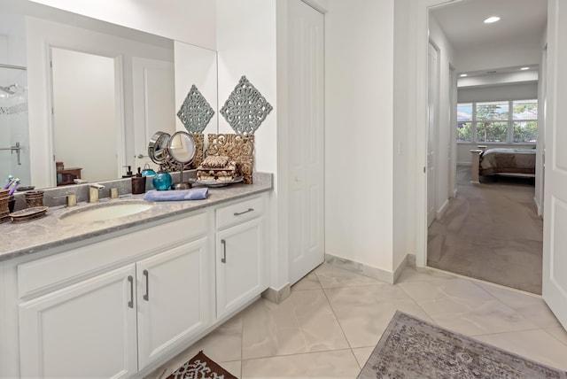 bathroom with connected bathroom, baseboards, recessed lighting, marble finish floor, and vanity