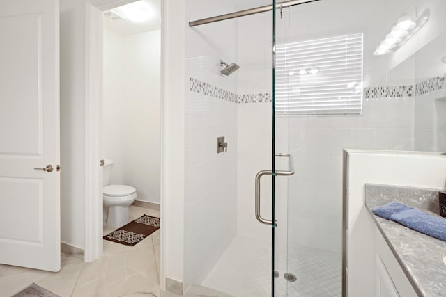 full bath with toilet, a stall shower, vanity, and tile patterned flooring