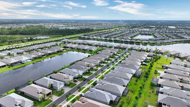 drone / aerial view with a residential view and a water view