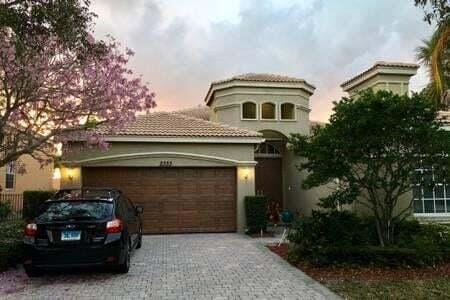 mediterranean / spanish-style home with an attached garage and decorative driveway