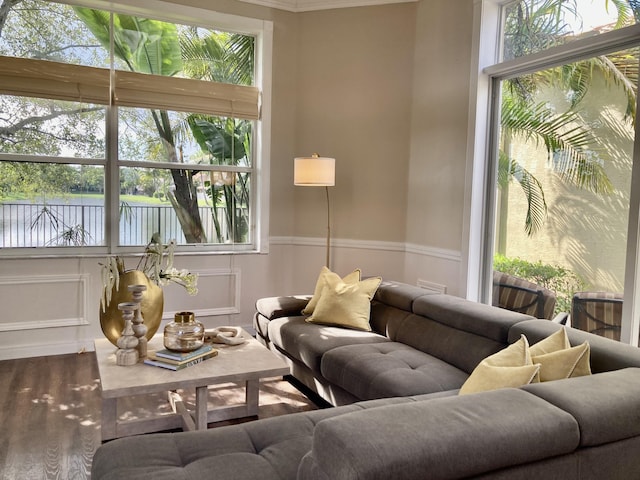 living room with wainscoting and a decorative wall