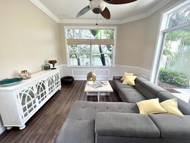 living area featuring a healthy amount of sunlight, wood finished floors, ceiling fan, and ornamental molding