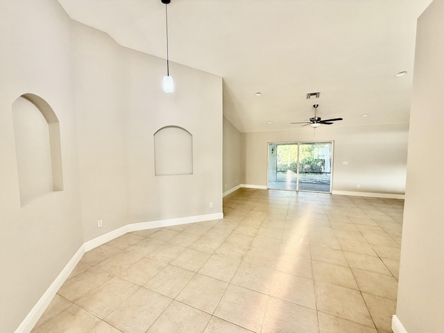 unfurnished room featuring visible vents, baseboards, a ceiling fan, and vaulted ceiling