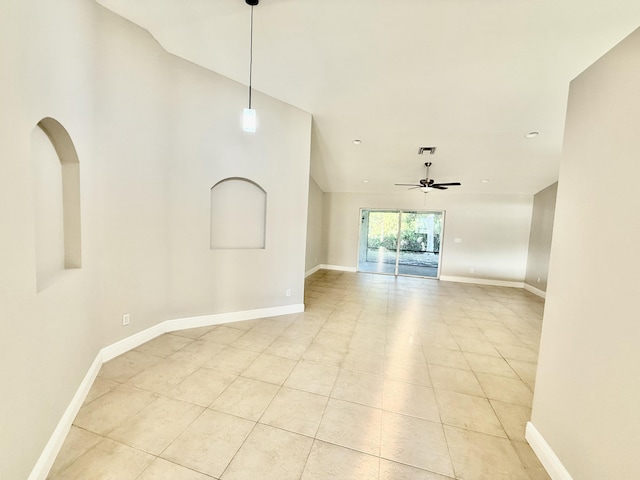 spare room with light tile patterned flooring, visible vents, baseboards, and a ceiling fan