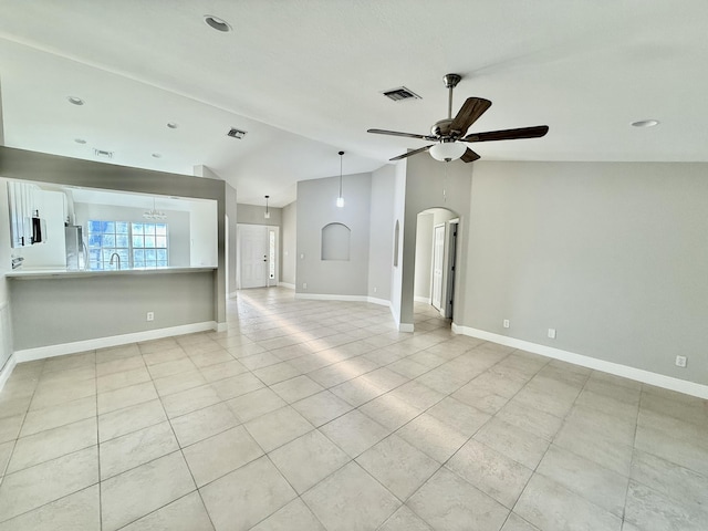 unfurnished living room featuring visible vents, a ceiling fan, light tile patterned floors, baseboards, and vaulted ceiling