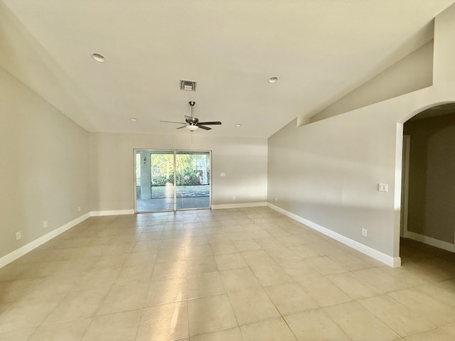 spare room featuring visible vents, baseboards, ceiling fan, lofted ceiling, and arched walkways