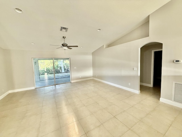 empty room featuring lofted ceiling, visible vents, arched walkways, and ceiling fan