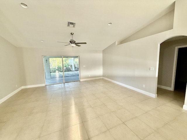 spare room with visible vents, lofted ceiling, a ceiling fan, arched walkways, and baseboards