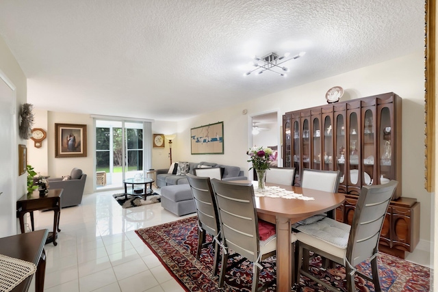 tiled dining room featuring a textured ceiling