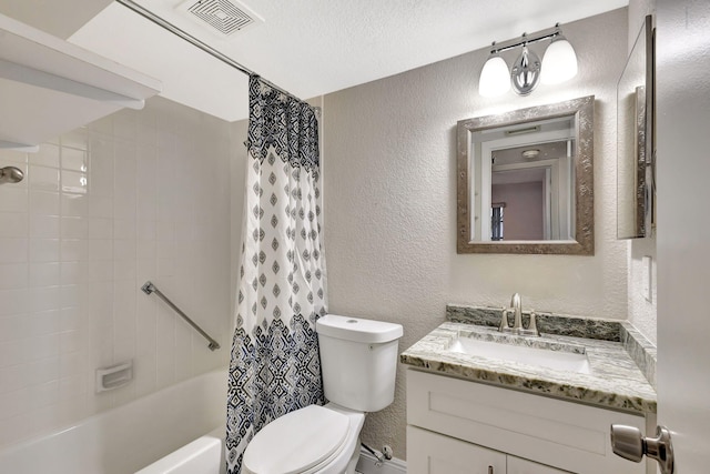 full bathroom featuring visible vents, shower / bath combo with shower curtain, toilet, a textured wall, and vanity