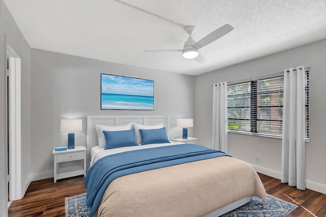 bedroom featuring a ceiling fan, baseboards, and wood finished floors