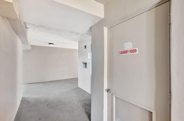 hallway with concrete floors